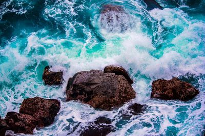 High angle view of rocks in sea