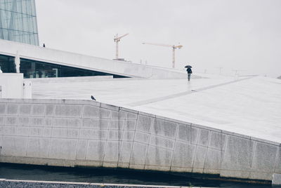 People walking on walkway at oslo opera house