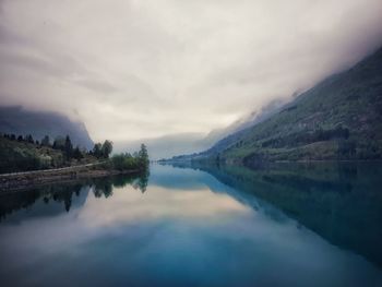 Scenic view of lake and mountains against sky