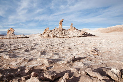Panoramic view of rocks on landscape against sky