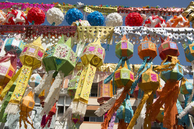 Low angle view of lanterns hanging by temple