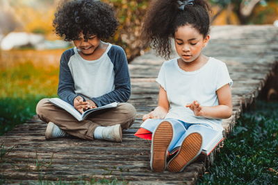 Siblings sitting outdoors