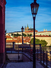 Street light in city against blue sky