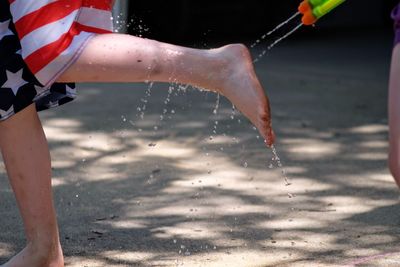 Midsection of person splashing water