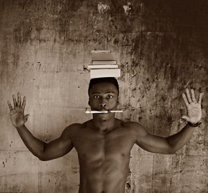 Portrait of young man standing against wall