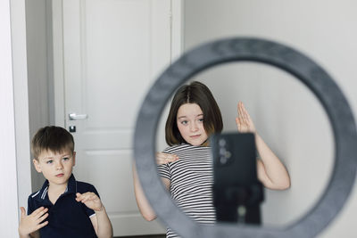 Boy and girl making dance tutorial at home