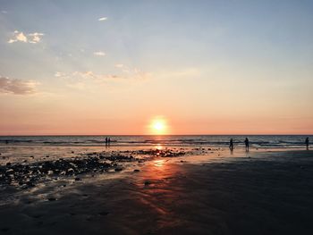 Scenic view of beach against sky during sunset