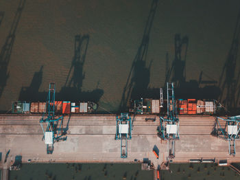 High angle view of cranes in city against sky