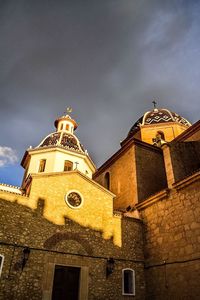 Low angle view of bell tower against sky