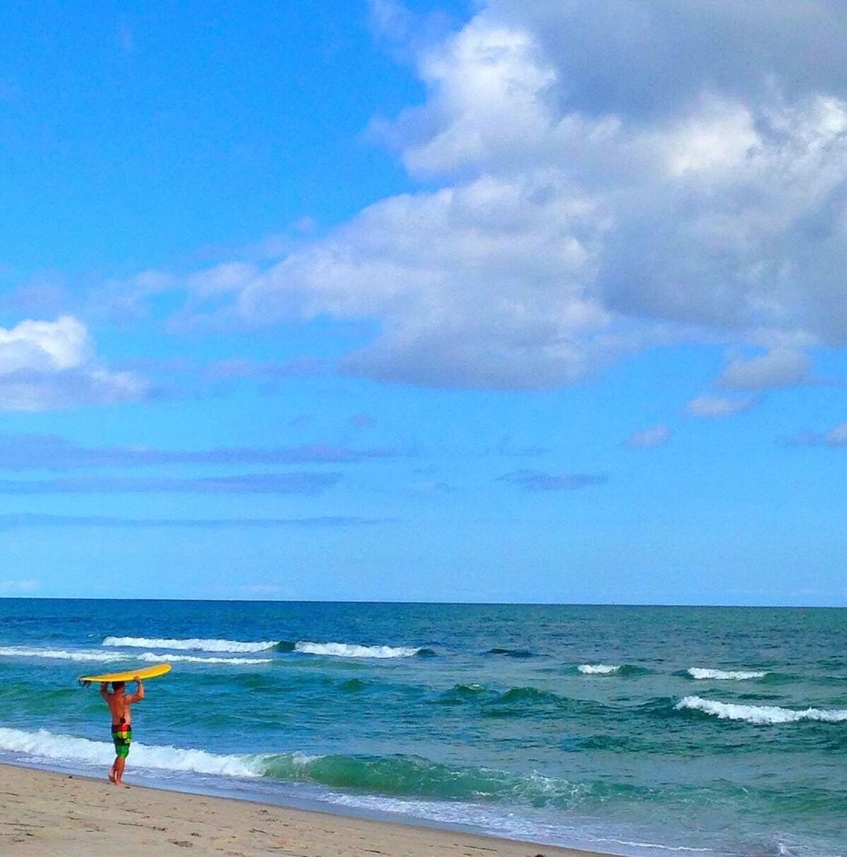 sea, horizon over water, beach, water, shore, sky, leisure activity, lifestyles, sand, scenics, beauty in nature, vacations, tranquility, tranquil scene, wave, nature, blue, rear view