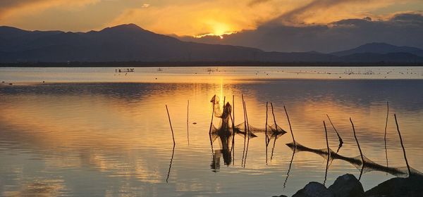 Scenic view of lake against sky during sunset