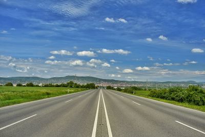 Empty road along countryside landscape