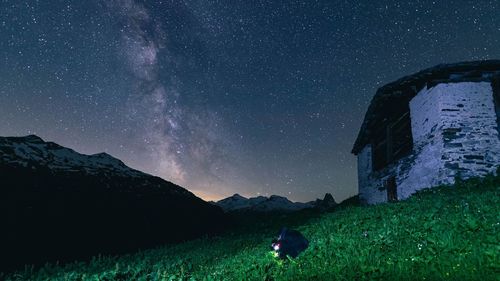 Scenic view of field against sky at night