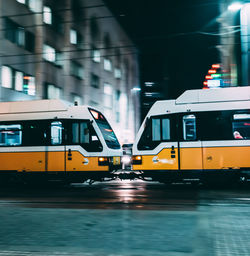 Blurred motion of train on street in city at night
