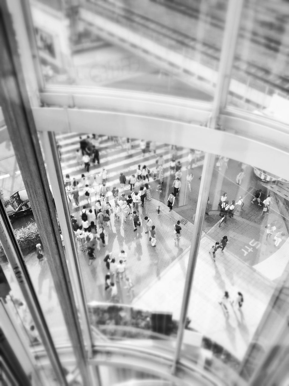 indoors, window, glass - material, transparent, public transportation, transportation, large group of people, high angle view, glass, person, vehicle interior, travel, mode of transport, rail transportation, airport, railroad station, ceiling, lifestyles, on the move