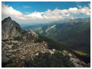 Scenic view of mountains against cloudy sky