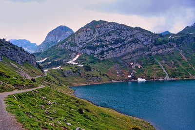 Scenic view of sea and mountains against sky