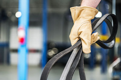 Cropped hand of man holding bicycle