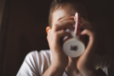 Portrait of boy holding camera