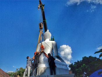 Low angle view of statue against blue sky