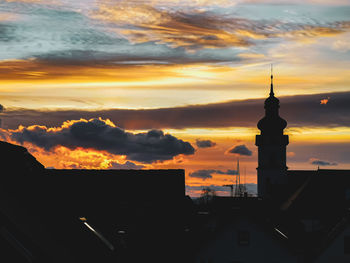 Silhouette buildings against sky during sunset