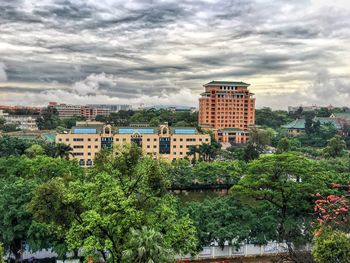 Buildings against cloudy sky