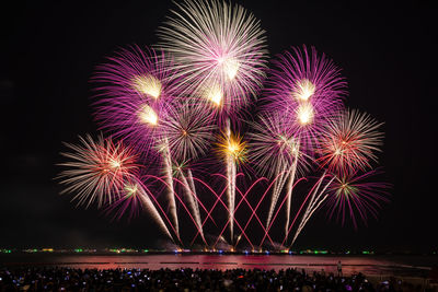 Low angle view of firework display at night