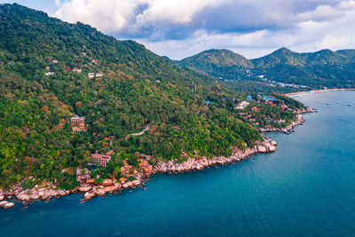 High angle view of sea and mountains against sky