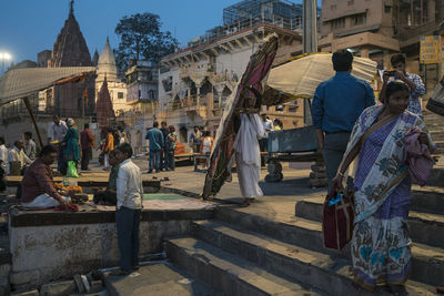 People at market stall in city