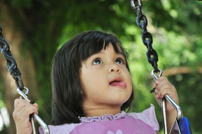 Cute girl sitting on swing