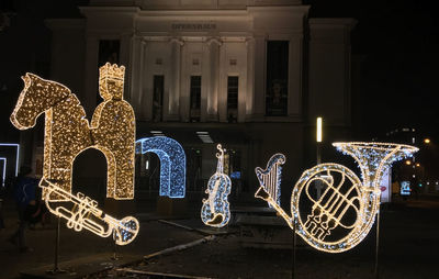 Graffiti on illuminated building at night
