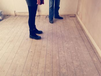 Low section of woman standing on tiled floor