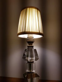 Close-up of illuminated electric lamp on table at home