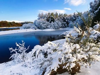 Scenic view of frozen lake against sky during winter