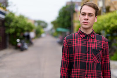 Portrait of young man standing outdoors