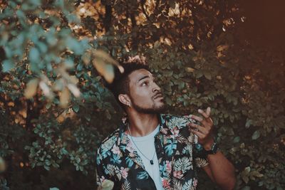 Portrait of young man looking away outdoors