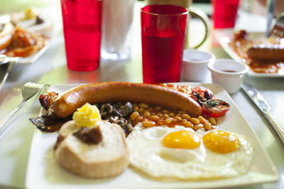 Close-up of english breakfast served in plate on table