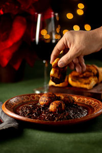 Close-up of person preparing food on table