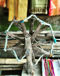 Close-up of clothespins hanging on clothesline against building