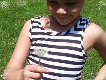 Portrait of a young woman holding grass