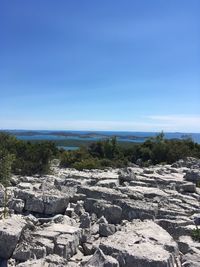 Scenic view of sea against clear blue sky