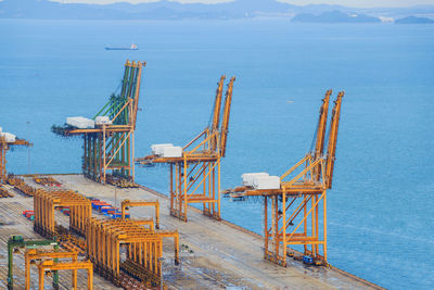 Construction site by sea against sky