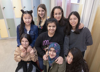 Smiling teenage girls looking at camera