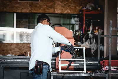 Side view of man working in factory