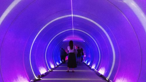 Rear view of man on escalator