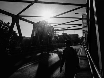 Rear view of man in city against sky