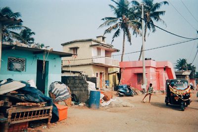 Houses by road against sky