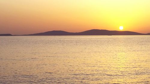 Scenic view of sea against orange sky