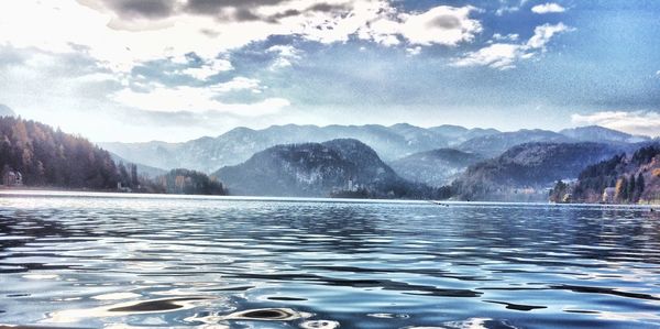 Scenic view of lake and mountains against sky