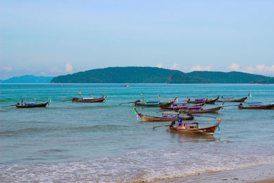 Boats moored on sea against sky
